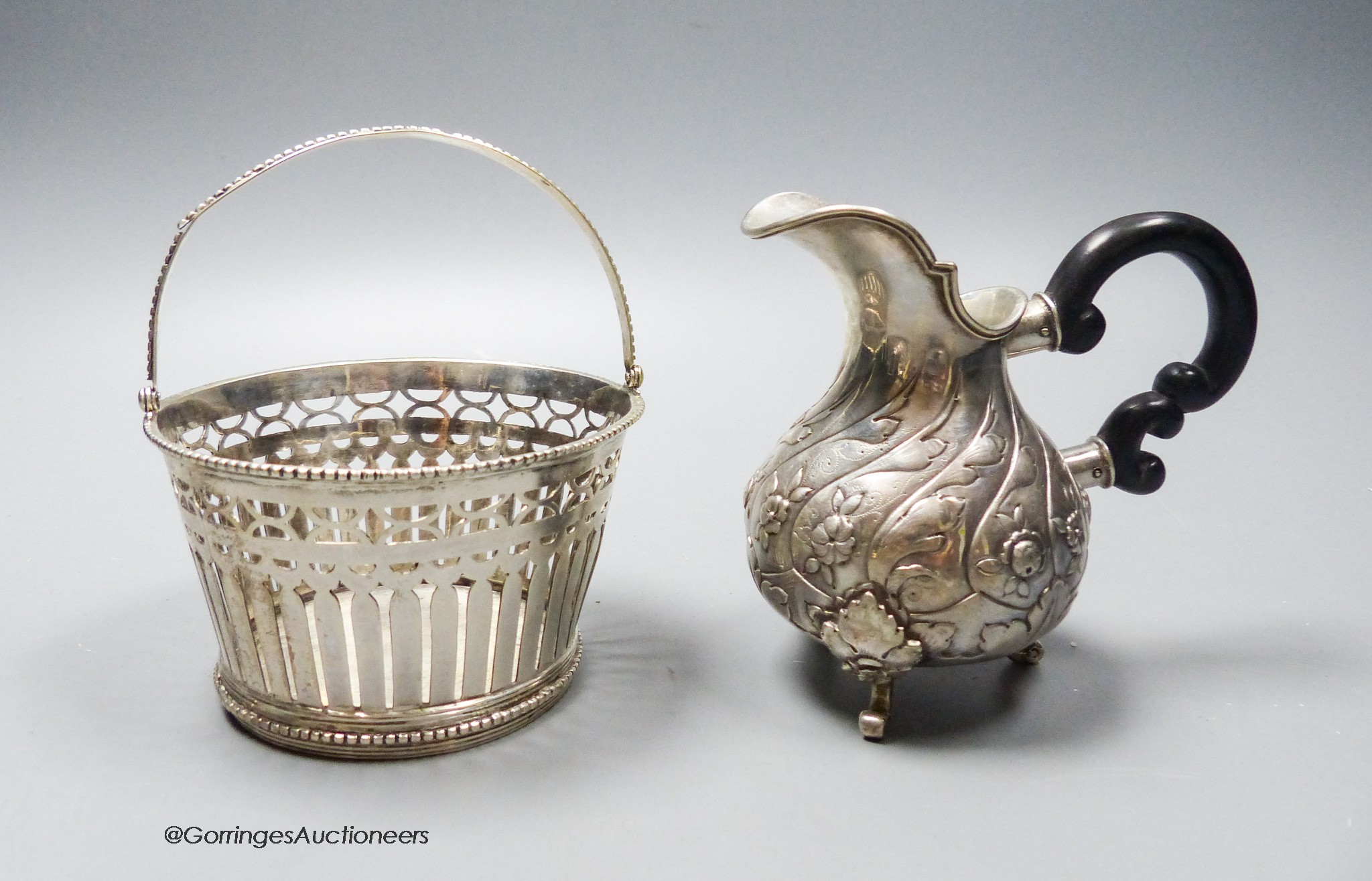 A 19th century Dutch white metal sugar basket (no liner), height 6cm and a Portuguese white metal cream jug, gross 7.5oz.
